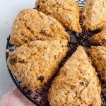 Scones on a black round wired rack with a pink napkin underneath.