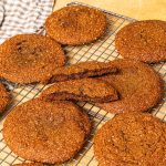 Chewy ginger spice cookies on a cooling rack.